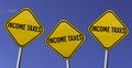 Income taxes due - three yellow signs with blue sky background