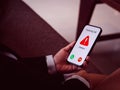 Incoming call with unknown caller, malicious phone calls concept. Red warning icon displayed showing on smart mobile phone. Royalty Free Stock Photo