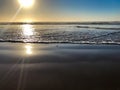 Incoming ocean waves and sunlight reflections from the sand beach at Agadir, Morocco, Africa at sunset Royalty Free Stock Photo