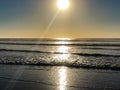 Incoming ocean waves and sunlight reflections from the sand beach at Agadir, Morocco, Africa at sunset Royalty Free Stock Photo