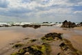 Incoming tide on sand and rocks