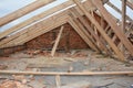 Incomplete attic house roof wooden frame construction. Unfinished attic house rooftop roofing construction with trusses, wooden