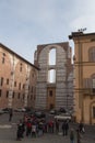 Incomplete facade of the planned Duomo nuovo and people on a square in front of it. Facciatone. Siena. Tuscany Italy. Royalty Free Stock Photo