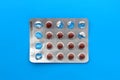 An incomplete pack of medicine pills lies on a blue background. Royalty Free Stock Photo