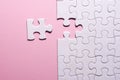 Incomplete white jigsaw puzzle pieces on pink background Royalty Free Stock Photo