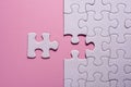 Incomplete white jigsaw puzzle pieces on pink background Royalty Free Stock Photo