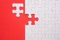 Incomplete white jigsaw puzzle pieces on red background Royalty Free Stock Photo
