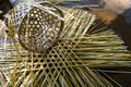 Incomplete work of basket weaving made of bamboo strips.