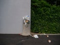 Inconsiderate people leave garbage on top and around an overflowing public bin.