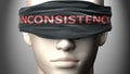 Inconsistency can make us blind - pictured as word Inconsistency on a blindfold to symbolize that it can cloud perception, 3d