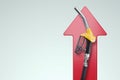 Increase in fuel prices, increase in the cost of gasoline. Gas station pistol on the background of a red arrow. Concept fuel, Royalty Free Stock Photo