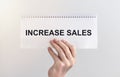 Increase sales inscription words on paper note in businessman hand Royalty Free Stock Photo