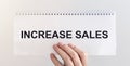 Increase sales inscription words on paper note in businessman hand Royalty Free Stock Photo