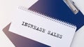 Increase sales inscription words on paper on table Royalty Free Stock Photo