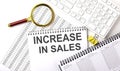 INCREASE IN SALES text written on notebook on chart with keyboard and planning Royalty Free Stock Photo