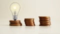 Increasing of electricity cost for residential and business users, expensive energy bill. Lots of coins and a light bulb