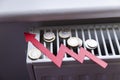 Increasing energy bills. Rising red arrow and coins on a heating radiator. Cost of living crisis Royalty Free Stock Photo