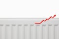 Increasing energy bills. Rising red arrow on a heating radiator. Cost of living crisis. recession inflation concept copy Royalty Free Stock Photo