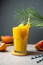 Increasing vitamins and minerals in diet. Glass of fresh orange juice with splashes and fresh fruits. Royalty Free Stock Photo