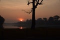 Sunrise over beautiful lake in angkor wat with sun reflecting in the water Royalty Free Stock Photo