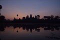 Violet sunrise over famous angkor wat temple with lake and reflection in the water with lillypad Royalty Free Stock Photo