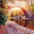 Incredible Autumn Landscape. Amazing sunset With colorful sky in Azalea and Rhododendron Park Kromlau .Rakotz Bridge, Rakotzbrucke Royalty Free Stock Photo