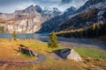 Incredible autumn scene of unique Oeschinensee Lake.