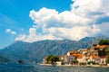 View of green wooded mountains and blue sea, blue sky and white clouds.