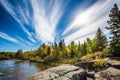 Incredible cirrus clouds and huge flat stones in Old Pinawa Dam Park. Indian summer in Manitoba, Canada. The concept of