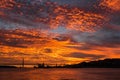 Incredible Golden sunset over the river Tagus, Bridge April 25 and the port of Lisbon, Portugal.