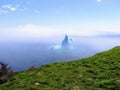 Incredible iceberg floating along the rugged coast beside the Sk Royalty Free Stock Photo