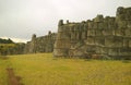 Incredible Inca stone walls of Sacsayhuaman fortress with statue of the Christ in distance, Cusco, Peru