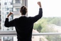 Incredible joy of win businessman with raised hands near office window Royalty Free Stock Photo