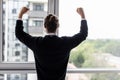 Incredible joy of win businessman with raised hands near office window Royalty Free Stock Photo