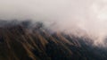 Incredible landscape of picturesque mountains and hills under fog