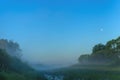 Incredible mist over the river at dawn. Night on the background of the moon and wildlife