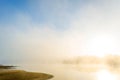 Incredible mystical fog and mist over the river in the early morning at dawn while fishing