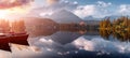 Incredible Nature Landscape. Beautiful view of traditional wooden boats on Strbske Pleso Lake during sunset. Awesome Sunny natural