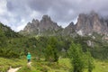 Incredible nature landscape in Dolomites Alps. Spring green blooming meadow. Panorama of Dolomites,Italy. Young woman Royalty Free Stock Photo