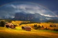 Incredible Nature landscape. Fantastic Dramatic Scenery of Alpe di Siusi or Seiser Alm during sunset with overcast sky and rainbow Royalty Free Stock Photo