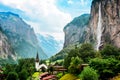 The Incredible picturesque landscape in Lauterbrunnen with canyon, church and famous Staubbach waterfall in the Swiss Alps,
