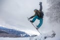 Incredible snowboard jump under the white snowy forest in a good winter day, freeride in a deep snow, ski season