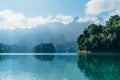 Incredible view of Cheow Lan lake with rainforest jungle on the banks with sun rays shining through white clouds. Surat Thani Royalty Free Stock Photo