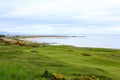 An incredible view of a golf hole in Scotland with the ocean in the background in Dornoch