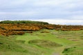 An incredible view of a golf hole in Scotland with the ocean in the background in Dornoch Royalty Free Stock Photo