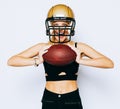 An incredibly beautiful blonde girl in a helmet posing in a black outfit and holding a ball. Sport. Match. American Royalty Free Stock Photo