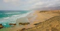 Incredibly beautiful empty long sandy smooth beach at sunrise, Cofete, Corralejo, Fuerteventura. Calm transparent azure Royalty Free Stock Photo