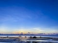 Beautiful, magical sunset, sunrise. Calm sea with boats on the background sky and clouds. Low tide on beach. Blue trend Royalty Free Stock Photo