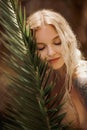 Sexy Beach Blonde Girl in Knitted Bikini With Palm Leaf Outdoors on Nature Royalty Free Stock Photo