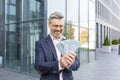 Incredibly happy businessman holds a stack of dollars in his hands, can& x27;t believe his luck, smiles and looks at the Royalty Free Stock Photo